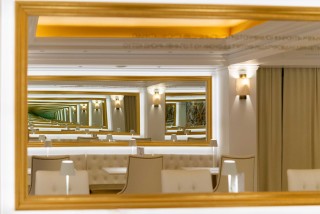 gallery galaxias hotel's lobby area with mirror and various tables and chairs